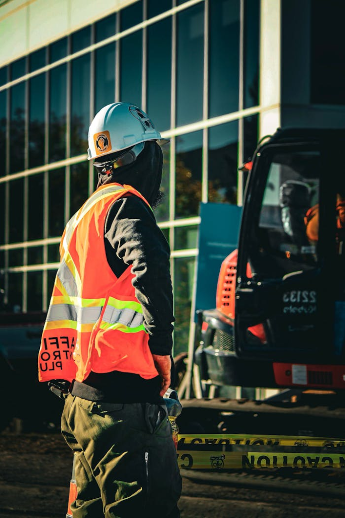 Construction worker in safety gear at an urban site in Ontario, Canada.