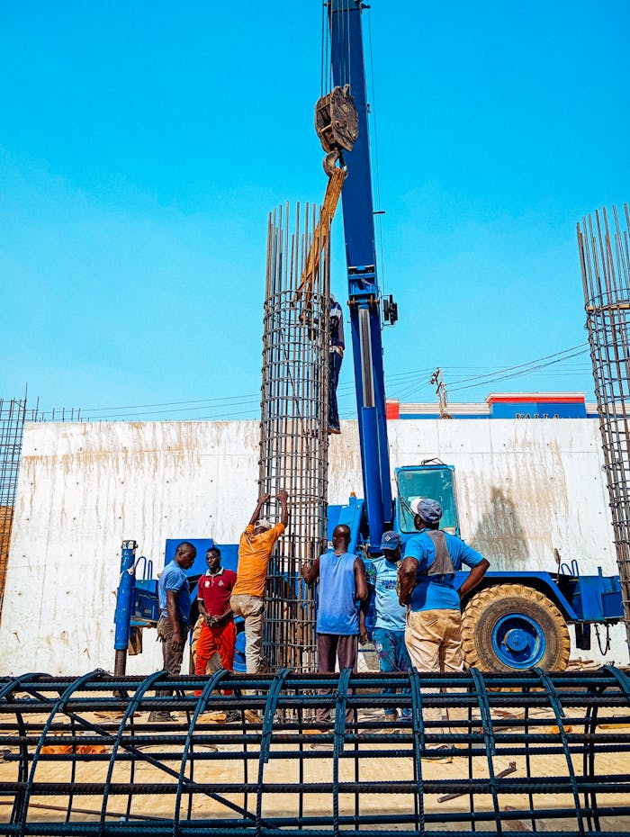 our-journey-02 Construction workers in Jimeta, Nigeria erecting rebar columns for a building project.